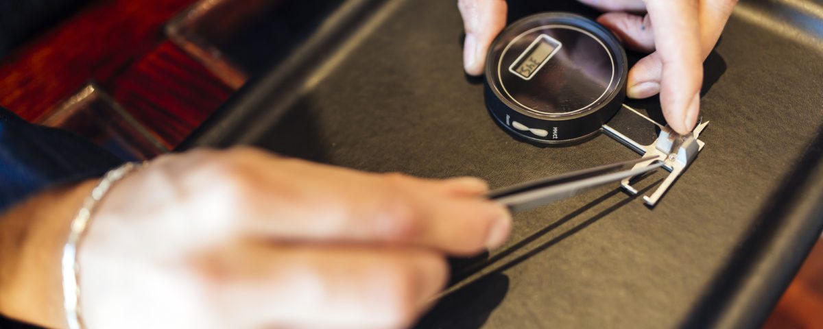 Jeweler checking size of diamond