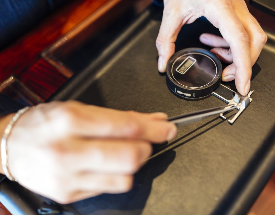 Jeweler checking size of diamond