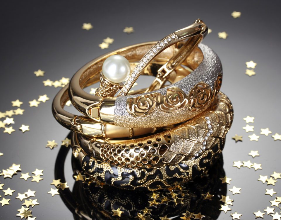 Beautiful golden bracelets on grey background